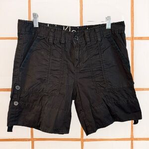 black cotton cargo shorts with a relaxed fit, button fly, and side pockets